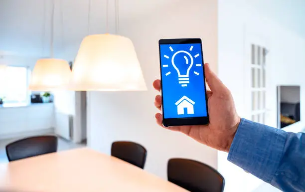 Photo of App on smart phone turns on light bulbs in smart home