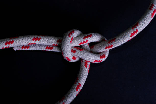 istock A knot in a red and white sailing rope on black background 1097520160