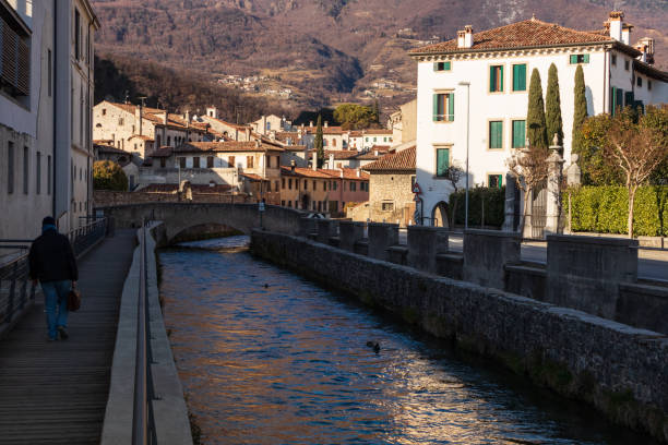 Vittorio Veneto, Italy - January 15, 2019:The historic district of Serravalle, with the village in the background and the canal that crosses it
