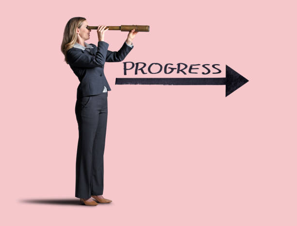 istock Woman Looking Through Spyglass Toward Progress 1097529664