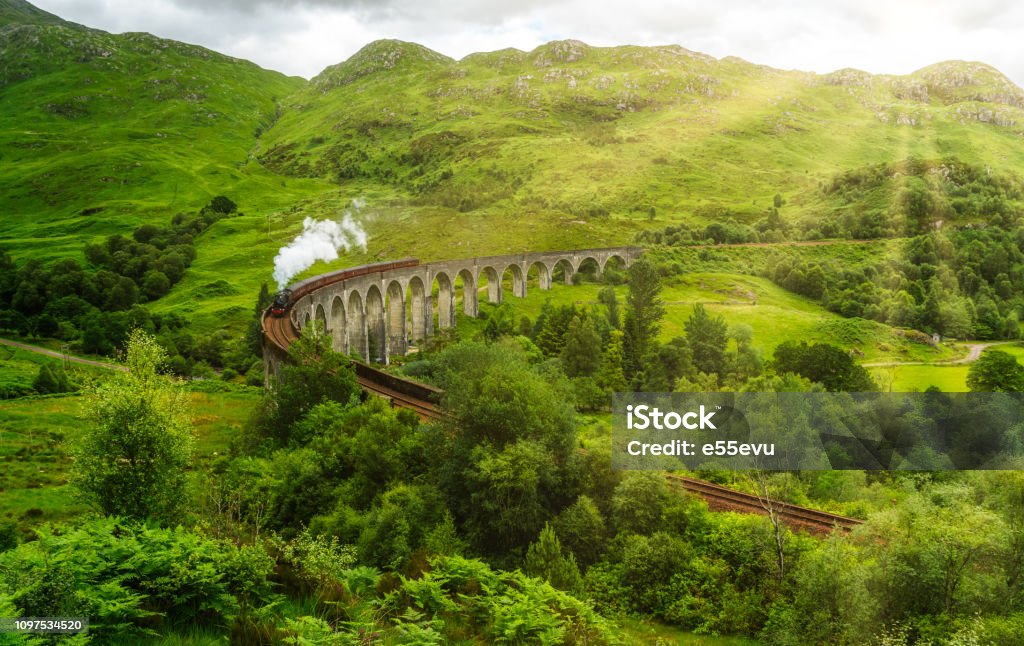Glenfinnan Railway Viaduct with the Jacobite steam, in Lochaber area of the Highlands of Scotland. Steam Train Stock Photo