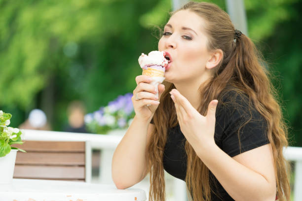 istock Young woman eating ice cream 1097539966