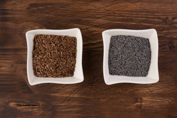 istock Poppy and flax seeds in a ceramic plates on wooden table background. Selective focus 1097540080