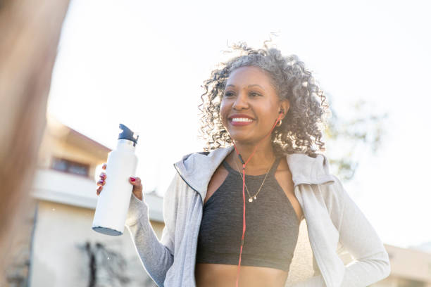 istock Black Woman Taking a Drink of Water while Working Out 1097541762