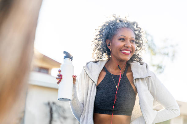 istock Black Woman Taking a Drink of Water while Working Out 1097541984