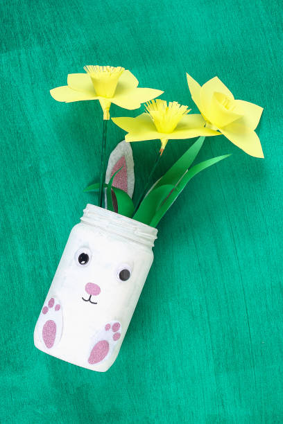 istock DIY Easter vase bunny from glass jar, felt, googly eyes on a green background 1097542038