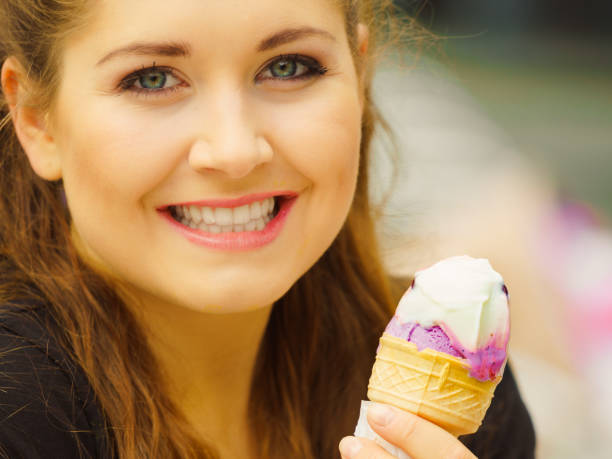 istock Young woman eating ice cream 1097542144