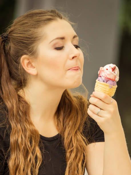 istock Young woman eating ice cream 1097542176