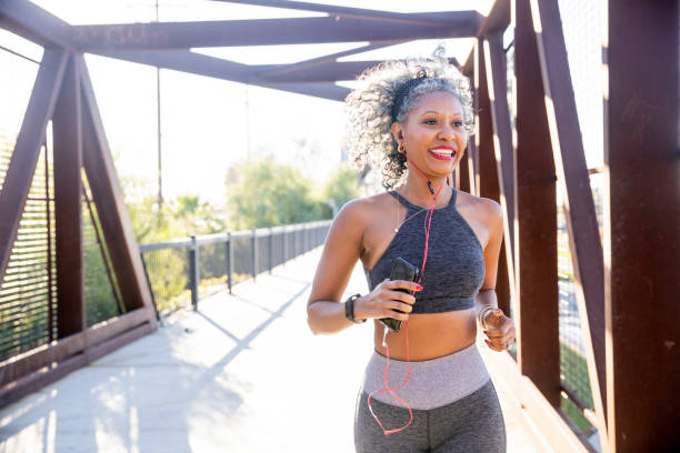 A Black Woman Running on a bridge