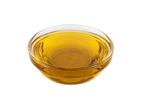 Oil in glass bowl isolated on white background