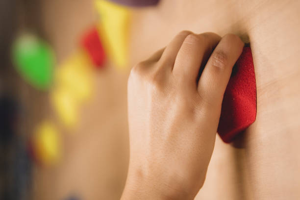 Caucasian girl climbing at indoor climbing wall