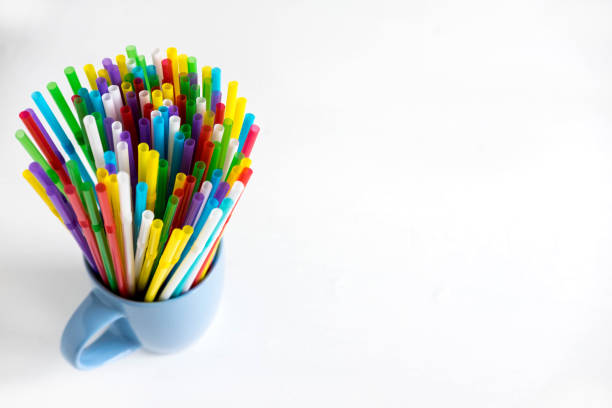 istock Background for a banner with plastic tubes in the cup. Frame for a banner with cocktail tubes. Party Banner Background 1097559868