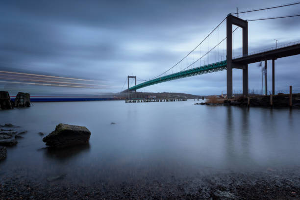 istock Light trails from a passenger cruise under Suspension bridge at Gothenburg Connecting main land to Industrial area of Hisingen in west coast of Sweden. 1097561440