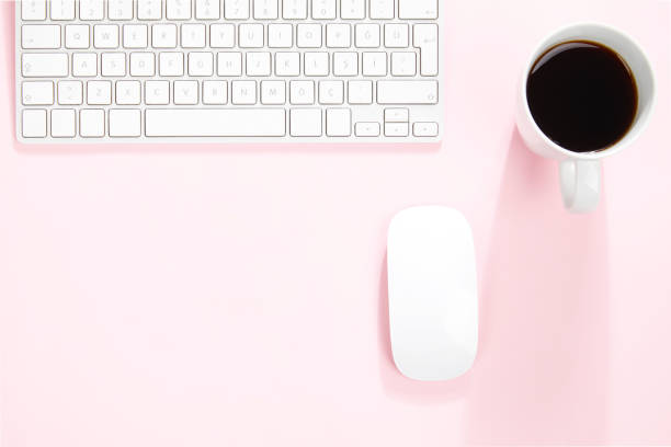 istock Pink office desk table with computer keyboard, mouse and cup of coffee 1097562706