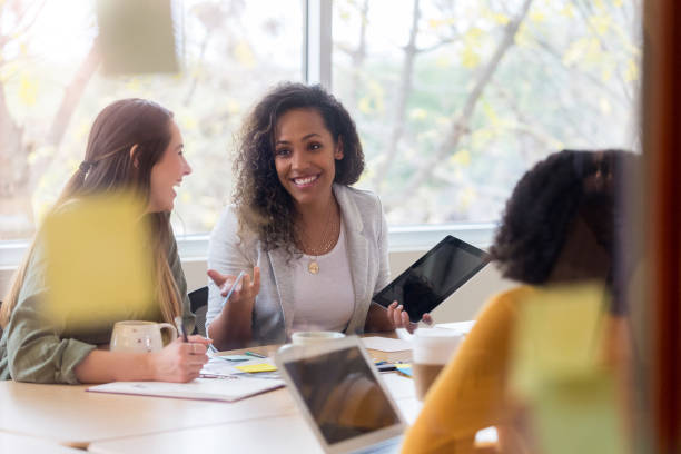 istock Happy female creative professional talking with clients 1097564216