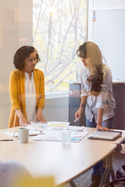 istock Female creative professionals brainstorm ideas 1097564226