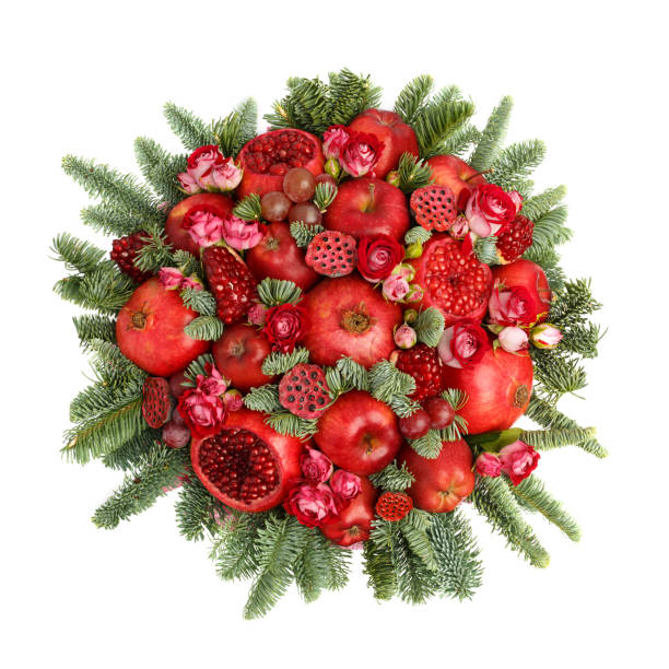 Huge edible fruit bouquet consisting of pomegranates, apples, grapes, rose flowers and fir twigs on white background. Top view Huge edible fruit bouquet consisting of pomegranates, apples, grapes, rose flowers and fir twigs on white background. Top view rose christmas red white stock pictures, royalty-free photos & images