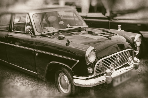 Stylish vintage car in sepia, classic beauty on retro style photography.
