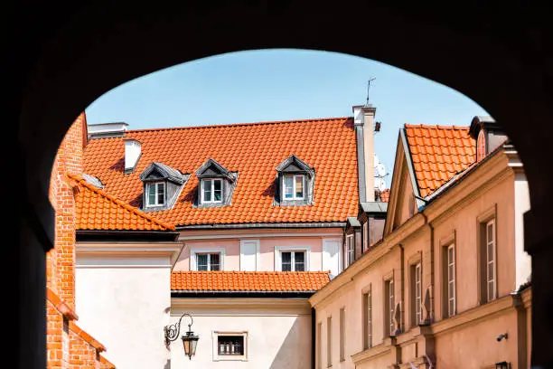 Warsaw, Poland street near old town market square with historic town architecture and window roof rooftop closeup framing arch tunnel