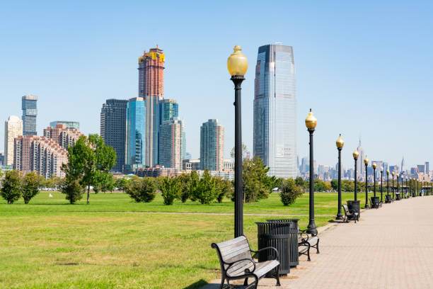 Jersey City Skyline Skyline of Jersey City, New Jersey along path in Liberty State Park jersey city stock pictures, royalty-free photos & images