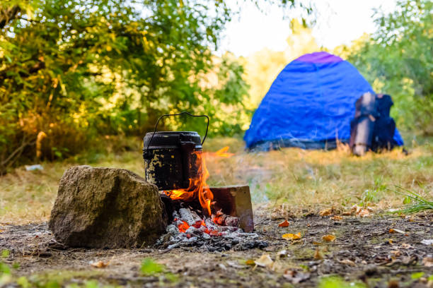 istock Cooking food in a kettle on bonfire. Tent on background 1097570018
