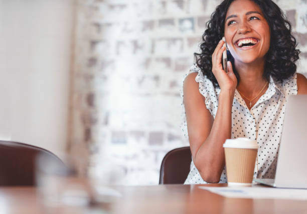 istock Attractive woman talking on a mobile phone with laptop computer. 1097574578