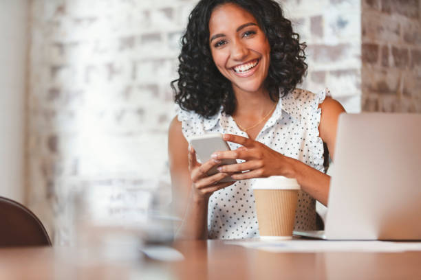 istock Attractive woman using a mobile phone with laptop computer. 1097574586