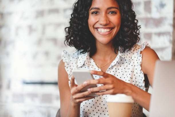 istock Attractive woman using a mobile phone with laptop computer. 1097574600
