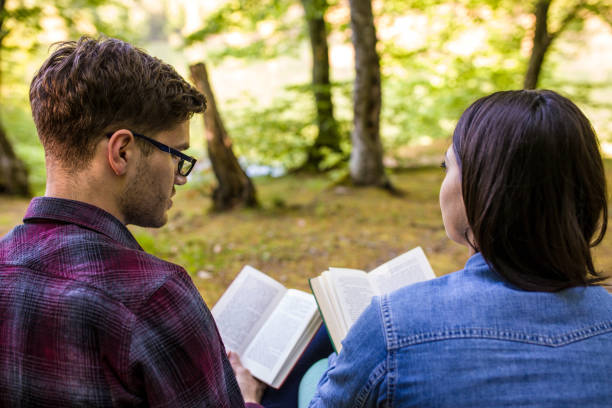 istock Couple Reading a Book On a Picnic 1097576698