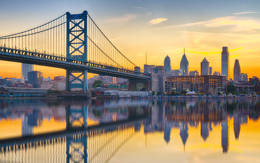 Philadelphia sunset skyline and Ben Franklin Bridge refection from across the Delaware River