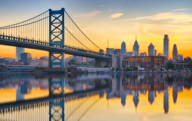 Philadelphia Sunset Skyline Refection Philadelphia sunset skyline and Ben Franklin Bridge refection from across the Delaware River new jersey photos stock pictures, royalty-free photos & images