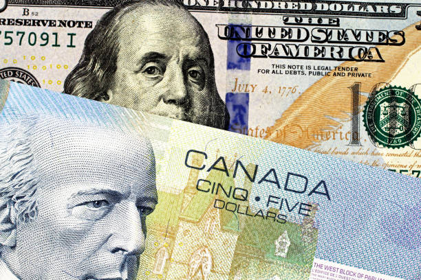 istock A blue Canadian five dollar bill with an American one hundred dollar bill 1097578342