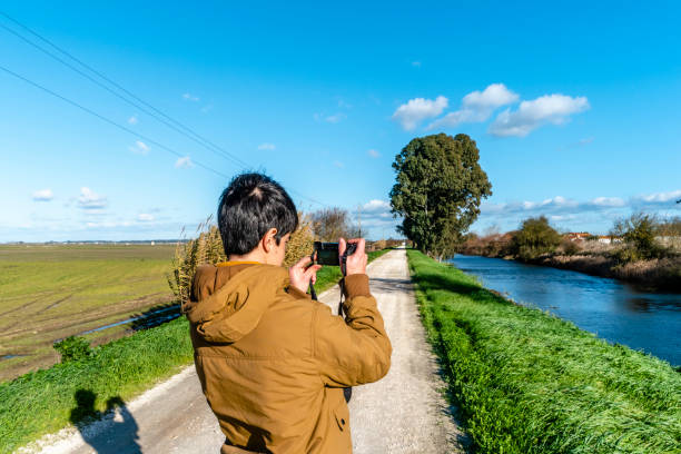 istock young man taking picture on natural background. 1097580638