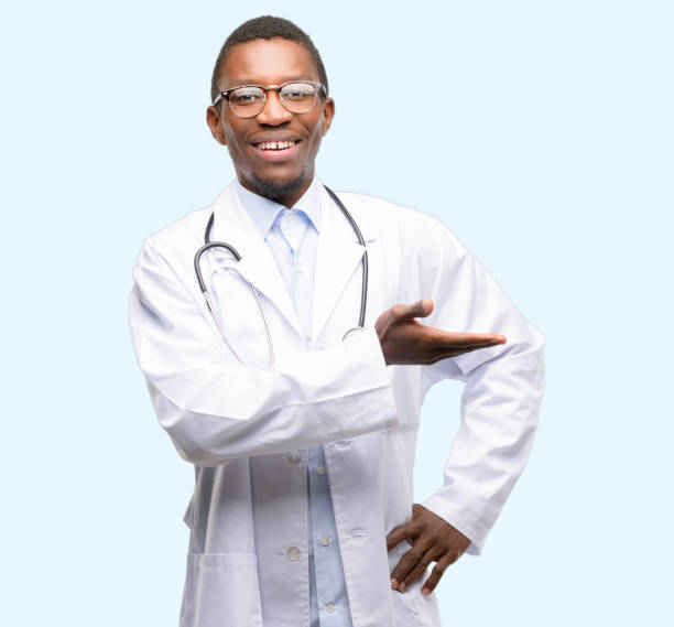 istock Young black doctor, medical professional holding something in empty hand 1097583272