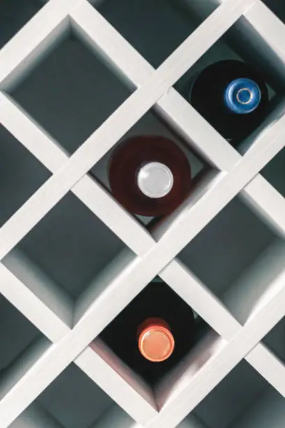 Photo of Wine rack. Wine cabinet. Wine bottle rack. Selective focus.