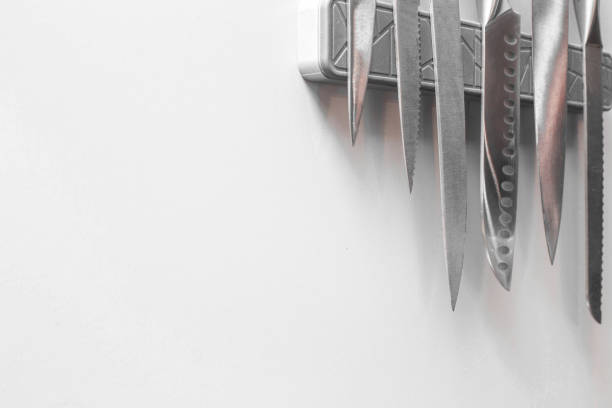 An assortment of different kitchen knives on a cutting board