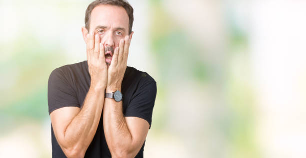 istock Handsome middle age hoary senior man over isolated background Tired hands covering face, depression and sadness, upset and irritated for problem 1097586754