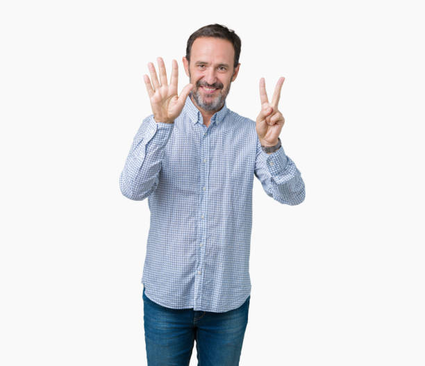 istock Handsome middle age elegant senior man over isolated background showing and pointing up with fingers number seven while smiling confident and happy. 1097587056