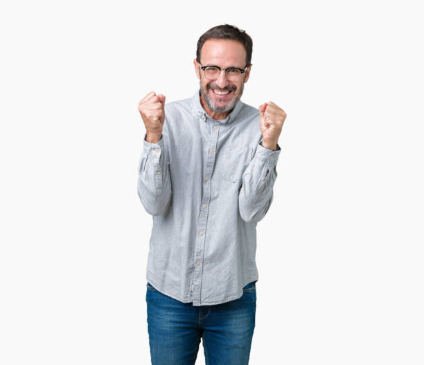 istock Handsome middle age elegant senior man wearing glasses over isolated background celebrating surprised and amazed for success with arms raised and open eyes. Winner concept. 1097587066