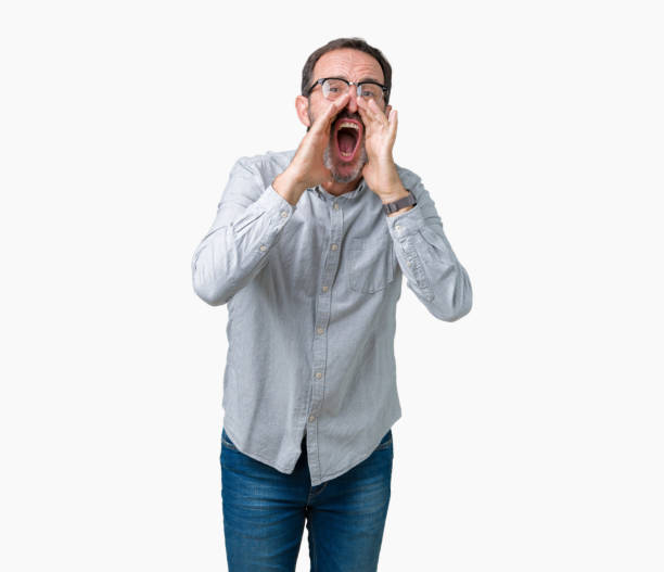 istock Handsome middle age elegant senior man wearing glasses over isolated background Shouting angry out loud with hands over mouth 1097587090