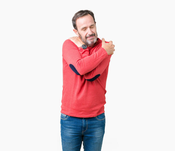 istock Handsome middle age hoary senior man wearing winter sweater over isolated background Hugging oneself happy and positive, smiling confident. Self love and self care 1097587522