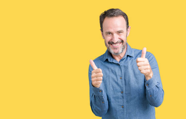 istock Handsome middle age elegant senior man over isolated background success sign doing positive gesture with hand, thumbs up smiling and happy. Looking at the camera with cheerful expression, winner gesture. 1097587932