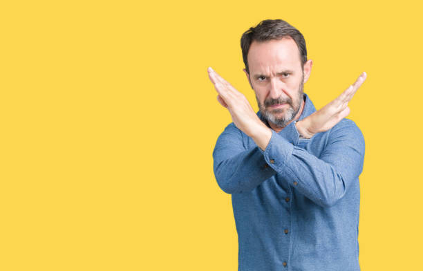 istock Handsome middle age elegant senior man over isolated background Rejection expression crossing arms doing negative sign, angry face 1097587948