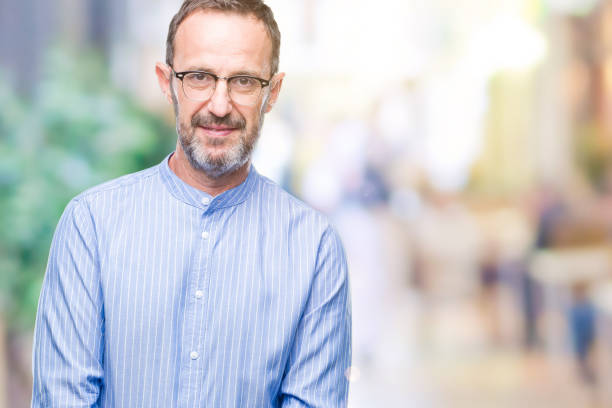 istock Middle age hoary senior man wearing glasses over isolated background with serious expression on face. Simple and natural looking at the camera. 1097595258
