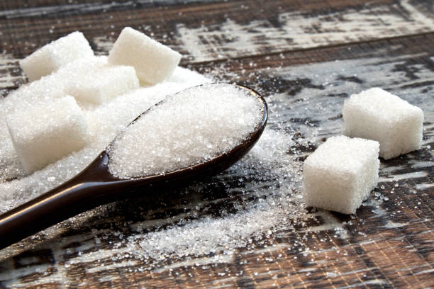 istock White sugar with spoon on wood background. 1097598820