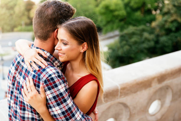 istock Young loving couple hugging in the street. 1097601558