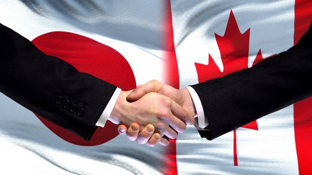 istock Japan and Canada handshake, international friendship relations, flag background 1097602086