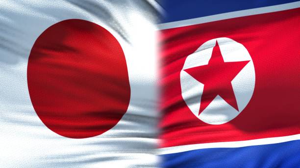 istock Japan and North Korea flags background, diplomatic and economic relations 1097602148