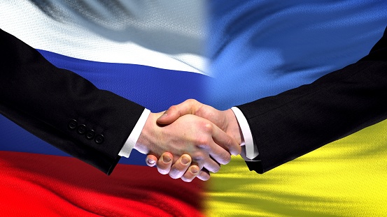Russia and Ukraine handshake, international friendship summit, flag background