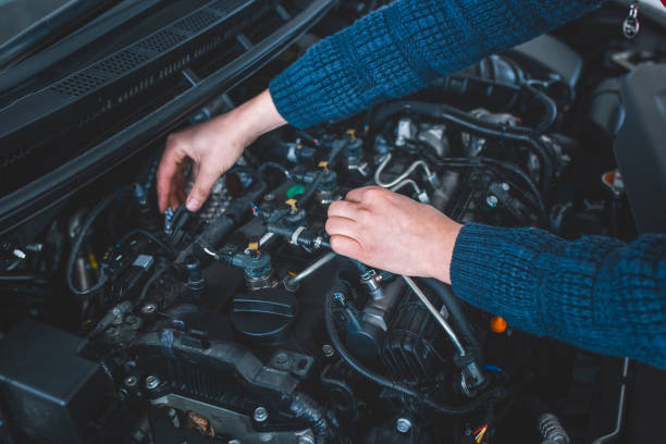 istock Auto mechanic working in garage. Repair service 1097602714